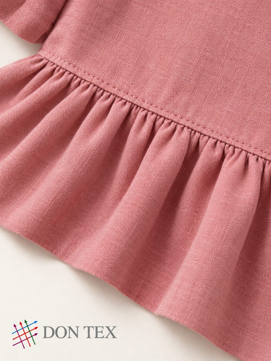 Gathered waist seam on a girls’ dress