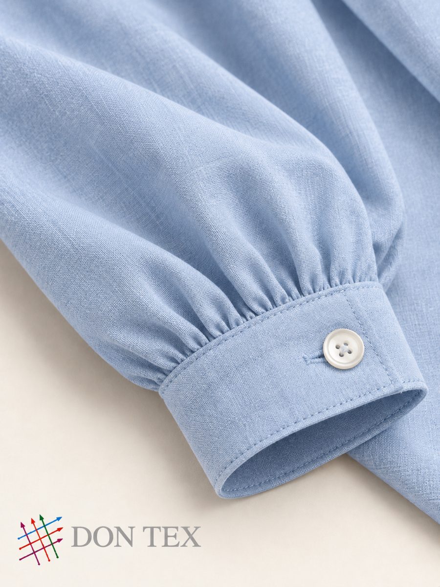 Gathered sleeve and buttoned cuff on a woven blouse