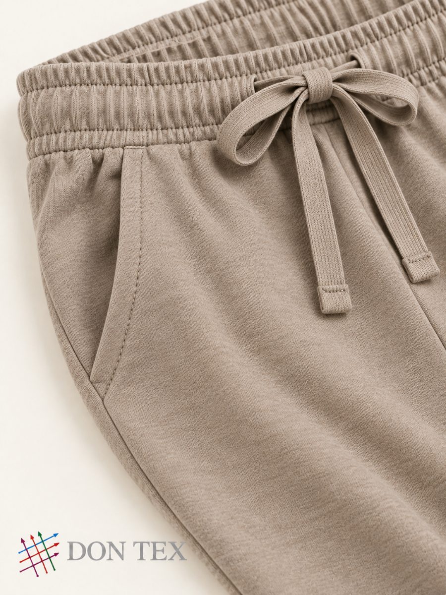 Elasticated waistband, drawcord and slanted pocket