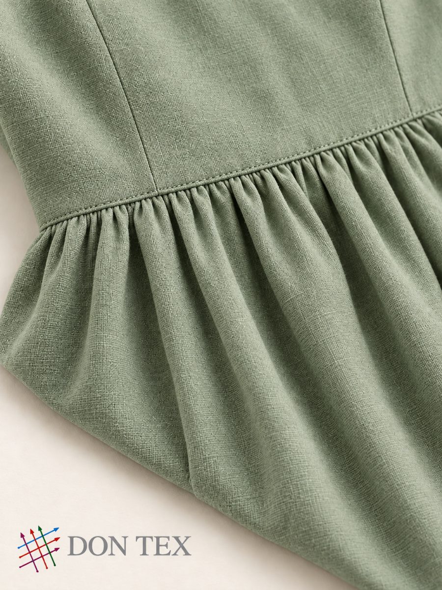 Close-up of the bodice darts and gathered waist seam
